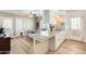Bright kitchen features an eat-in counter, wood floors, and white cabinets at 856 N Evergreen St, Chandler, AZ 85225
