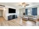 Inviting living room featuring wood flooring, a ceiling fan, and a comfortable sectional couch at 856 N Evergreen St, Chandler, AZ 85225