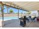 This covered patio overlooks a backyard oasis with a pool and mature landscaping at 856 N Evergreen St, Chandler, AZ 85225