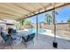 Covered patio with furniture overlooking a sparkling pool and landscaped backyard at 856 N Evergreen St, Chandler, AZ 85225