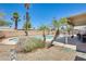 Sparkling pool surrounded by palm trees and a patio area, perfect for outdoor relaxation at 856 N Evergreen St, Chandler, AZ 85225