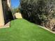 Private backyard boasts synthetic grass, mature trees, and desert landscaping at 9070 E Gary Rd # 152, Scottsdale, AZ 85260