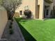 Side yard features lush synthetic grass and mature landscaping at 9070 E Gary Rd # 152, Scottsdale, AZ 85260