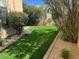 Picturesque backyard with synthetic grass, mature trees, and well-maintained landscaping at 9070 E Gary Rd # 152, Scottsdale, AZ 85260
