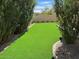 Beautiful backyard showcases lush synthetic grass, mature shrubs, and desert landscaping at 9070 E Gary Rd # 152, Scottsdale, AZ 85260