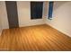 A bedroom features a window, gray door, and hardwood floors at 9070 E Gary Rd # 152, Scottsdale, AZ 85260