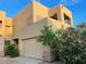 Two-story tan home with a tan garage door and desert plants at 9070 E Gary Rd # 152, Scottsdale, AZ 85260