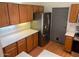 A kitchen features stainless steel appliances, wood cabinets, and white countertops at 9070 E Gary Rd # 152, Scottsdale, AZ 85260