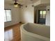 A living room features hardwood floors, white walls, and a ceiling fan at 9070 E Gary Rd # 152, Scottsdale, AZ 85260