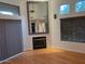 Living room features a modern fireplace, tall ceilings, and a large mirror at 9070 E Gary Rd # 152, Scottsdale, AZ 85260