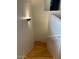 A well lit staircase with a wood handrail and wood steps are featured at 9070 E Gary Rd # 152, Scottsdale, AZ 85260