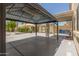 Covered patio area with view of the backyard, shed and patio furniture at 9133 W Virginia Ave, Phoenix, AZ 85037