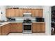 Functional kitchen with stainless steel appliances and wood cabinets, perfect for cooking at 9133 W Virginia Ave, Phoenix, AZ 85037