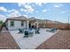 Spacious backyard featuring a cozy seating area with fire pit and lounge chairs at 9238 W Roma Ave, Phoenix, AZ 85037