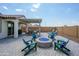 This backyard features a firepit and lounge chairs, perfect for relaxing and entertaining friends at 9238 W Roma Ave, Phoenix, AZ 85037