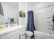 This well-lit bathroom features white cabinets and a bathtub with shower, providing a clean and functional space at 9238 W Roma Ave, Phoenix, AZ 85037