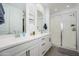 This bathroom features dual sinks and a large glass shower, providing plenty of room to get ready in the morning at 9238 W Roma Ave, Phoenix, AZ 85037