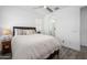 This bedroom offers neutral paint, and a ceiling fan, with an attached bathroom for extra convenience at 9238 W Roma Ave, Phoenix, AZ 85037