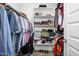 This walk-in closet provides ample storage, with shelves and hanging rods for clothes, shoes, and accessories at 9238 W Roma Ave, Phoenix, AZ 85037
