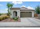 Charming single-story home featuring a two-car garage and desert landscaping at 9238 W Roma Ave, Phoenix, AZ 85037