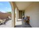 Inviting front porch with ample seating and stylish decor, creating a welcoming entrance at 9238 W Roma Ave, Phoenix, AZ 85037