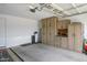 This garage features custom wood cabinets providing ample storage space and organization at 9238 W Roma Ave, Phoenix, AZ 85037