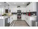 Well-lit kitchen with stainless steel appliances, white cabinets, and subway tile backsplash at 9238 W Roma Ave, Phoenix, AZ 85037