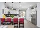 Modern kitchen featuring a breakfast bar, stainless appliances, and white cabinetry at 9238 W Roma Ave, Phoenix, AZ 85037