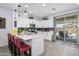 Bright, modern kitchen with stainless steel appliances, a breakfast bar and exterior access at 9238 W Roma Ave, Phoenix, AZ 85037