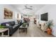 Spacious living room with modern decor, wood tile floors, and natural light at 9238 W Roma Ave, Phoenix, AZ 85037
