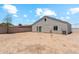 View of the backyard, ready for landscaping, with a detached garage or guest house in the background at 9471 W Magnum Dr, Arizona City, AZ 85123