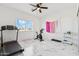 Bright bedroom featuring exercise equipment, white marble floors, and large windows for natural light at 9471 W Magnum Dr, Arizona City, AZ 85123