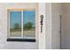 Close-up showing the house number next to a window with blinds for privacy and light control at 9471 W Magnum Dr, Arizona City, AZ 85123