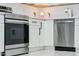 Modern kitchen with stainless steel appliances, white cabinets, and sleek countertops for a clean aesthetic at 9471 W Magnum Dr, Arizona City, AZ 85123