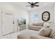 Inviting living room with a neutral palette, a large sectional sofa, and a modern black mirror at 9471 W Magnum Dr, Arizona City, AZ 85123