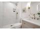 Bright bathroom features a tiled shower, gold fixtures and a modern vanity at 1051 E Millett Ave, Mesa, AZ 85204