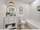 Elegant bathroom featuring a stylish vanity, round mirror, updated fixtures, and tiled shower/tub combo at 1051 E Millett Ave, Mesa, AZ 85204