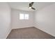 Cozy bedroom with neutral carpet, a modern ceiling fan, and a bright window for natural light at 1051 E Millett Ave, Mesa, AZ 85204