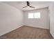 Light-filled bedroom with a modern ceiling fan, neutral carpet, and a bright window at 1051 E Millett Ave, Mesa, AZ 85204