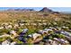 Expansive aerial view of a desert community with beautiful homes surrounded by native vegetation and mountain vistas at 11299 E Greythorn Dr, Scottsdale, AZ 85262