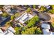 Overhead shot of estate featuring a backyard pool and patio surrounded by lush trees and landscaping at 11299 E Greythorn Dr, Scottsdale, AZ 85262