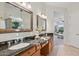 Bathroom with double sinks, granite countertops, and decorative mirrors at 11299 E Greythorn Dr, Scottsdale, AZ 85262