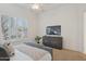 Well-lit bedroom featuring shuttered windows and a dresser at 11299 E Greythorn Dr, Scottsdale, AZ 85262