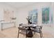 Cozy breakfast nook with a round table, modern chairs, and a sunny window with plantation shutters at 11299 E Greythorn Dr, Scottsdale, AZ 85262