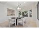 Dining room with a modern chandelier, lots of natural light, and contemporary decor at 11299 E Greythorn Dr, Scottsdale, AZ 85262