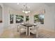 Elegant dining area with a stylish chandelier, large windows, and seating for six, perfect for entertaining at 11299 E Greythorn Dr, Scottsdale, AZ 85262