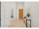 Entryway featuring a light wood door with tiled floor, neutral decor, and artwork at 11299 E Greythorn Dr, Scottsdale, AZ 85262