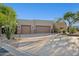 Desert home exterior featuring a wide driveway, two-car garage and desert landscaping at 11299 E Greythorn Dr, Scottsdale, AZ 85262