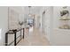 Hallway leading to a living room with tiled floor, neutral decor, and natural light at 11299 E Greythorn Dr, Scottsdale, AZ 85262