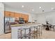 Open-concept kitchen and breakfast nook featuring a breakfast bar, stainless steel appliances, and granite countertops at 11299 E Greythorn Dr, Scottsdale, AZ 85262